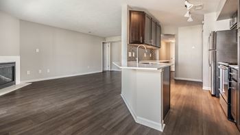 A kitchen with a refrigerator, sink, and cabinets